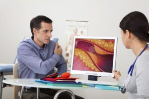 Patient learning about cholesterol and its effects on the body from a doctor