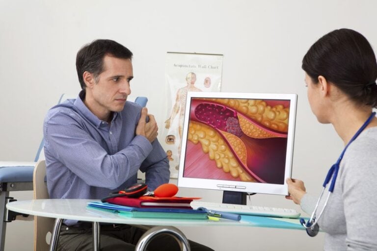 Patient learning about cholesterol and its effects on the body from a doctor